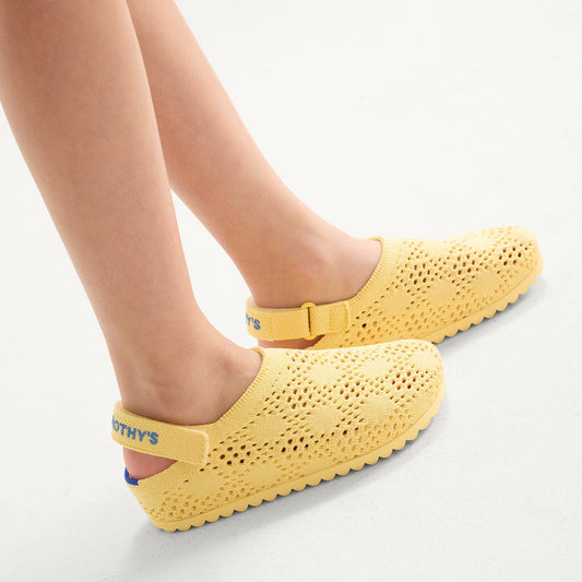 hover | A child wearing The Kids Clog in Sunny Crochet.