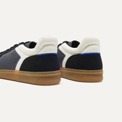 Close up of the heel of The RS01 Sneaker in Obsidian Black, with the padded ankle collar and Rothy's signature blue halo.