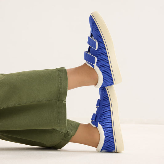 hover | A child modeling The Kids Strap Sneaker in Buoy Open-Knit.