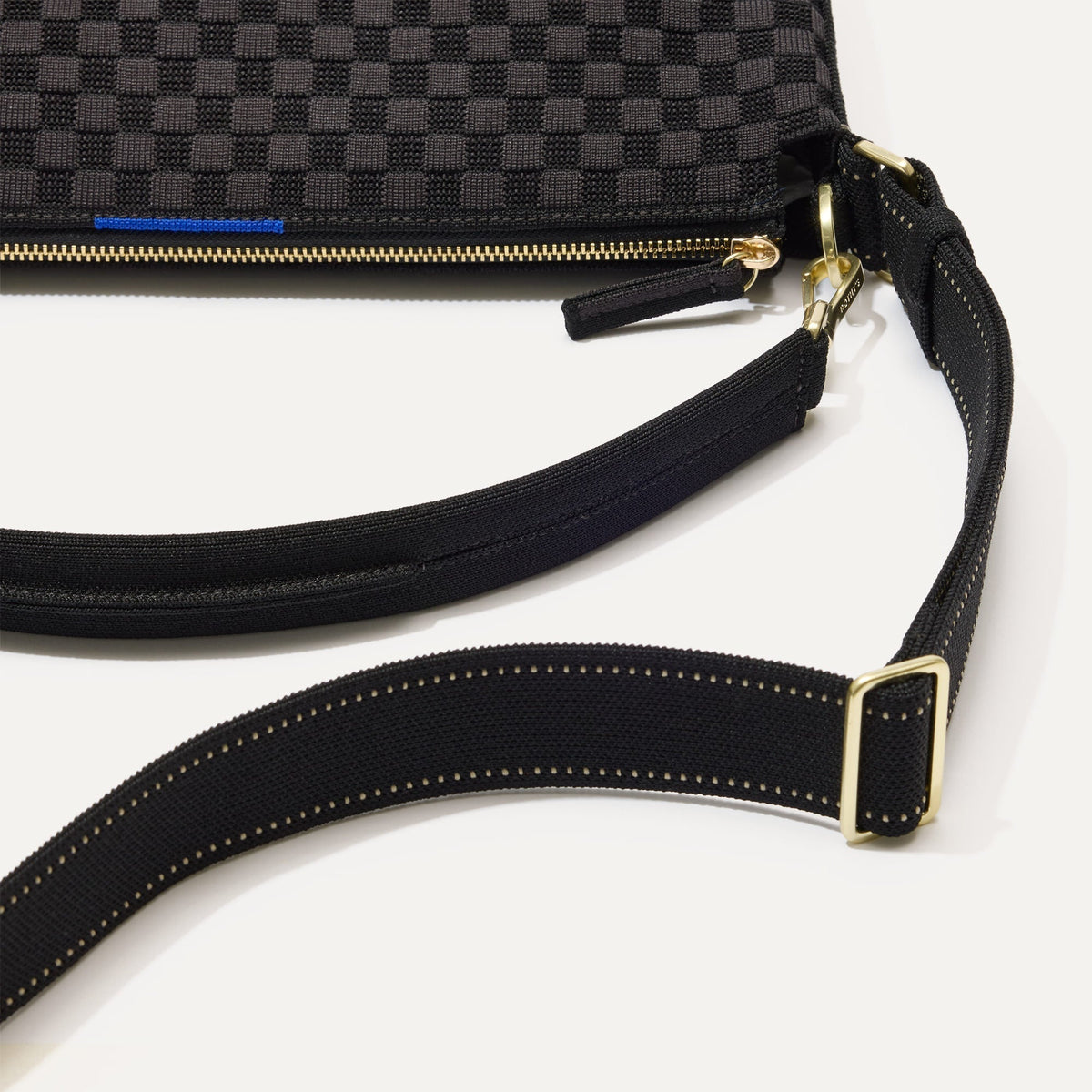 The Mini Zip Bucket in Black Sand lying flat, shown at a diagonal view from the left.