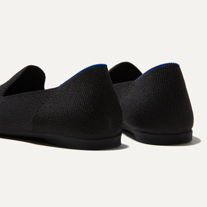 Close up of the heel of The Almond Loafer in Black, with Rothy's signature blue halo.