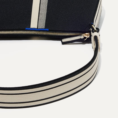 A closeup of The Casual Crossbody in Black & Ivory Stripe, focusing on the crossbody strap.