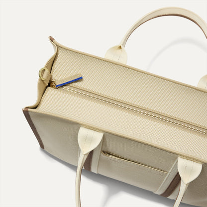 The Classic Tote in Buttercream, shown from above, with the top zipper closed.
