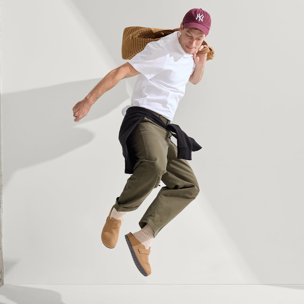model | Alternate view of a model wearing The Men's Clog in Butternut.