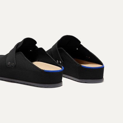 Close up of the heel of The Men's Clog in Soft Black, with Rothy's signature blue halo.