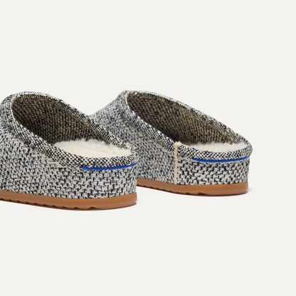 Close up of the heel of The Cozy Clog in Cookies and Cream Bouclé, with Rothy's signature blue halo.