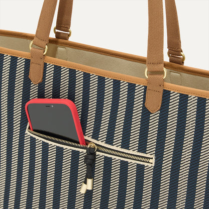 A closeup of The Two-Way Tote in Shadow, focusing on the exterior zip pocket.