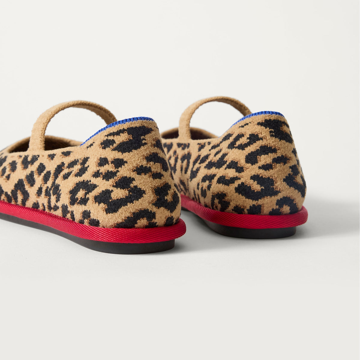 Close up of the heel of The Cruiser Mary Jane in ReVelvet Cherry Cat, with Rothy's signature blue halo.