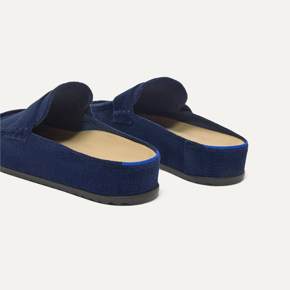 Close up of the heel of The Penny Clog in ReVelvet™ Navy, with Rothy's signature blue halo.